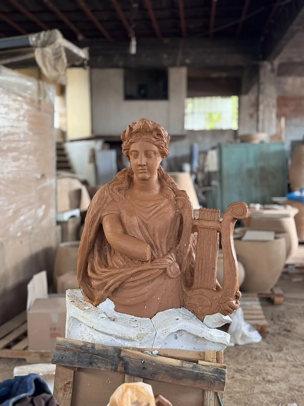 Terracotta muse modelled at full scale in the workshop