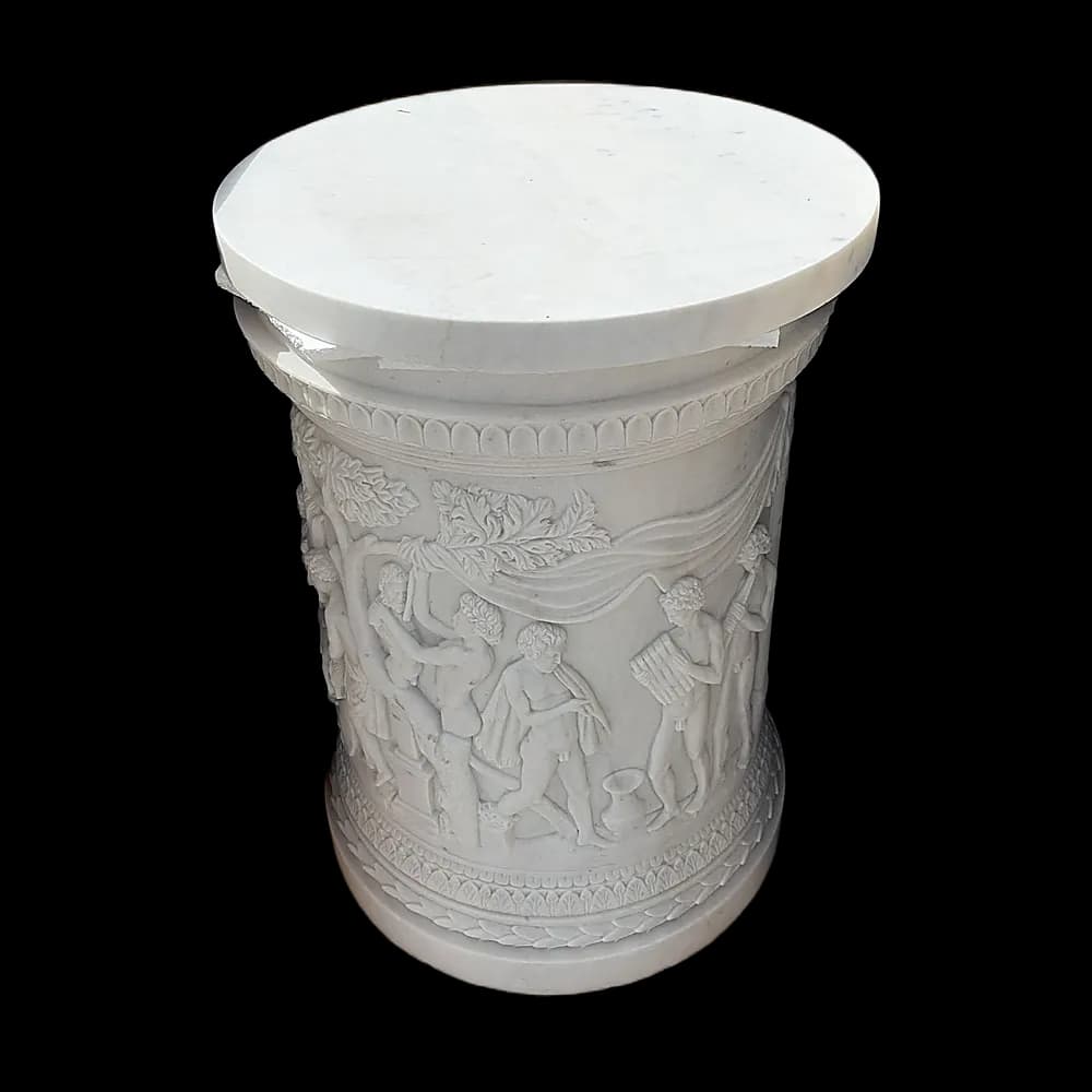 Carved marble pedestal with figures in relief